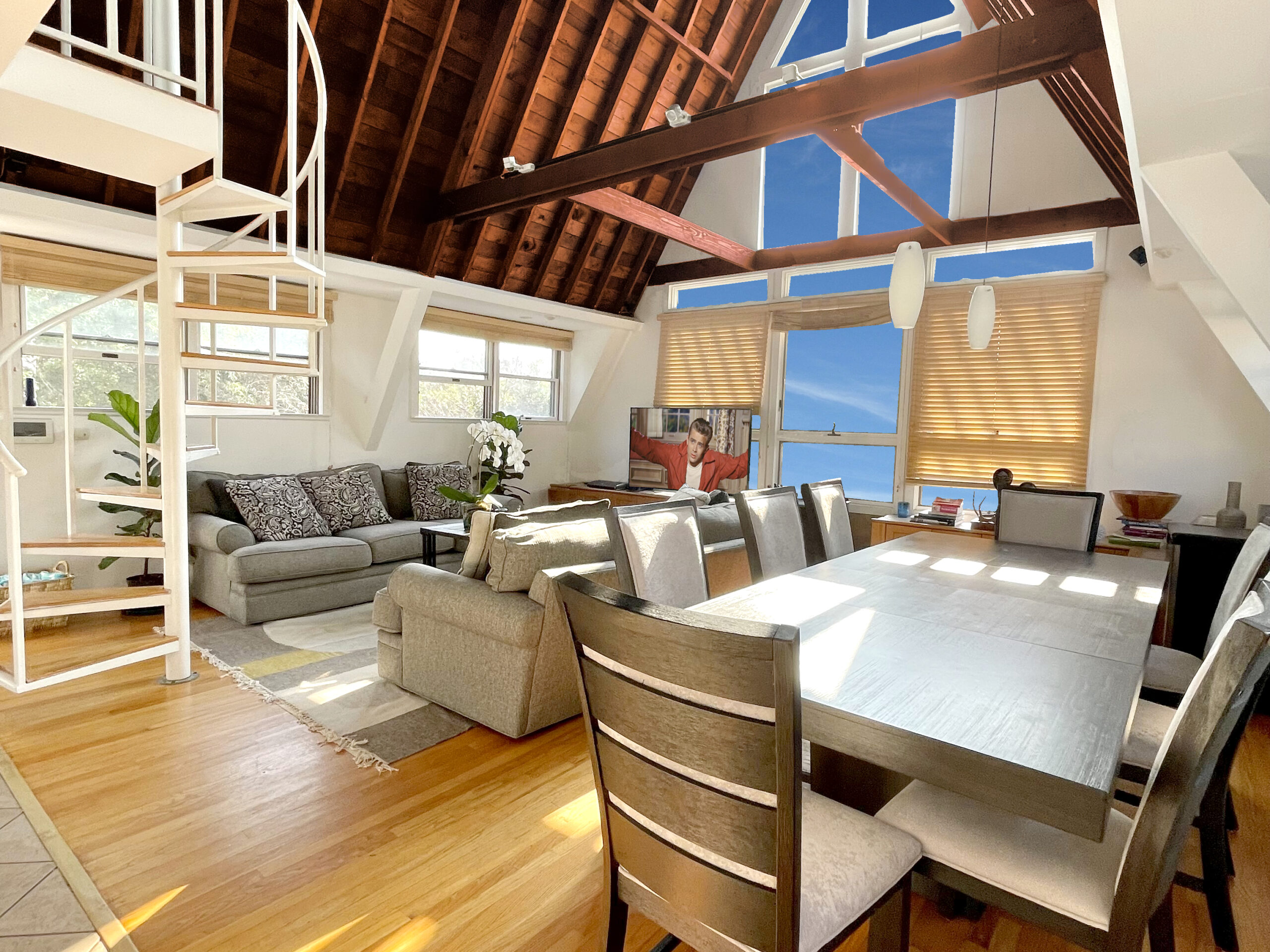 Solid wood beams above and massive picture windows surround beautifully appointed living and dining rooms.